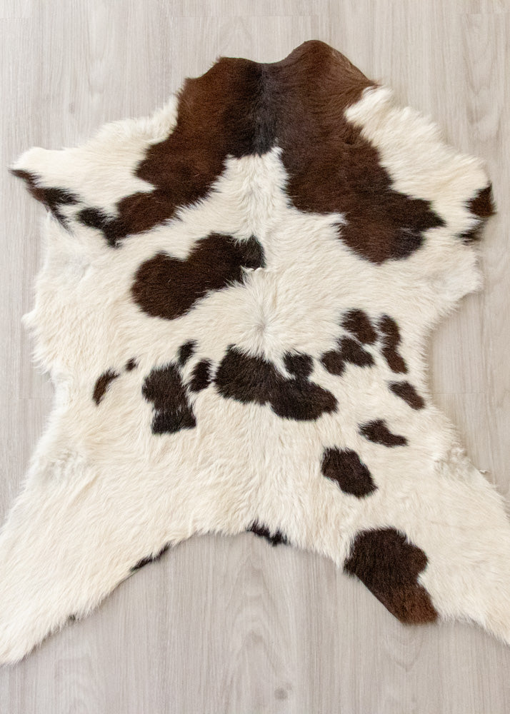calfskin rug with brown and white pattern on a wooden floor