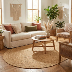 Cozy living room with beige sofa, round wooden coffee table, and decorative elements, oval plain natural jute rug