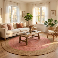 Living room with a round pink and beige jute rug, wooden coffee table, and white sofa.