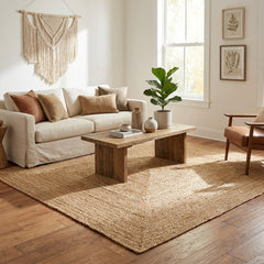 Living room with beige sofa, wooden coffee table, and square jute rug.