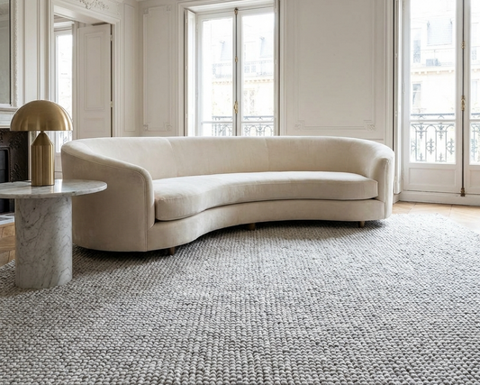 Large wool rug defining open-plan living area
