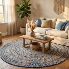 Living room with a round blue and beige jute rug, wooden coffee table, and beige sofa.