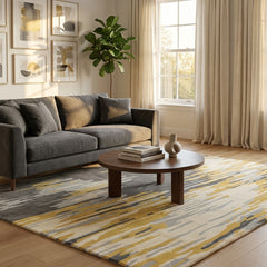 Living room with a gray sofa, wooden coffee table, and patterned rug.
