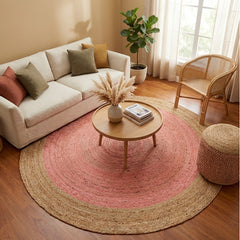 Living room with a round pink and beige jute rug, white sofa, and wooden coffee table.
